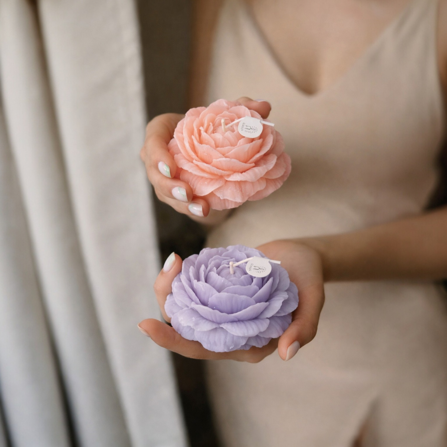 A women holding flower candles in hands, beige surrounding